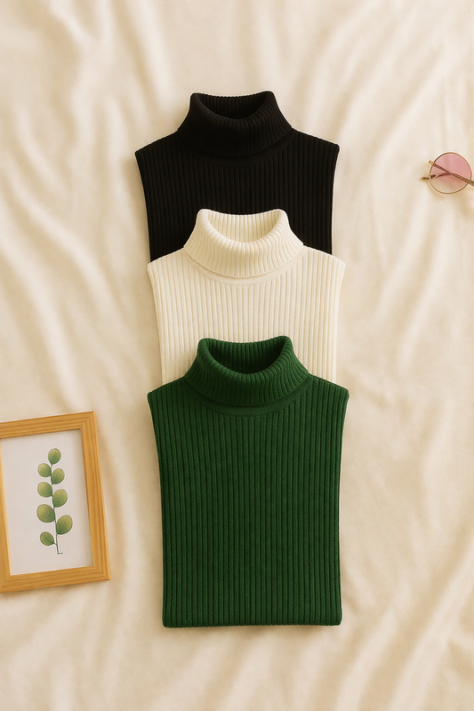 Three knit turtleneck shirts in black, white, and green on a beige surface.