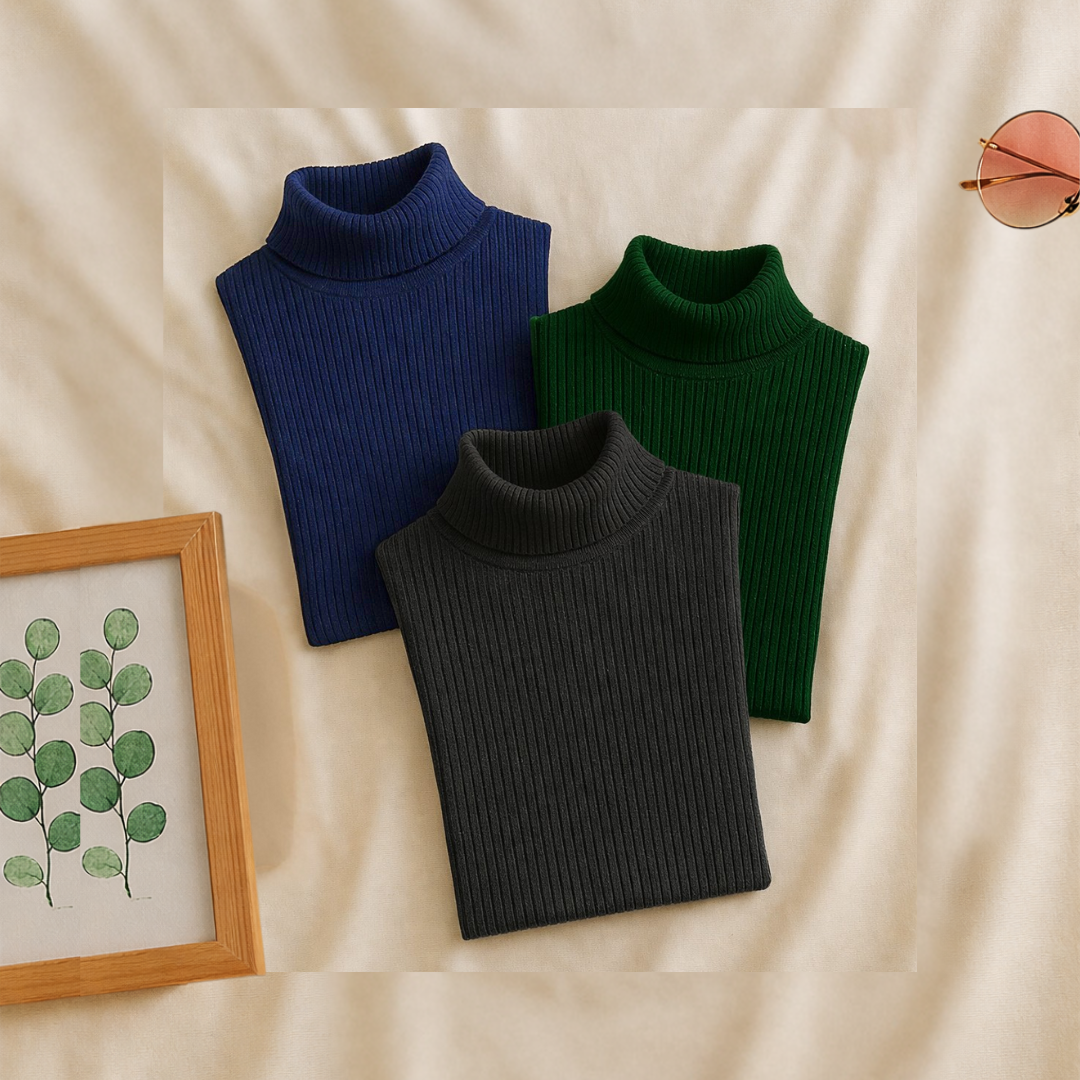 Three turtleneck sweaters in blue, black, and green on a beige fabric background.