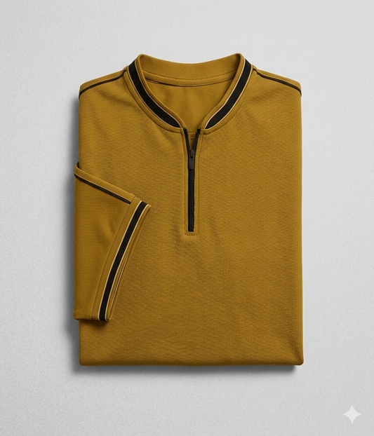 Premium mustard zip polo shirt for men with contrast striped collar and sleeves folded flat lay on grey background.